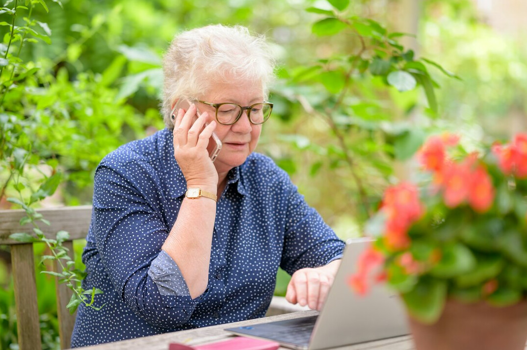 senior woman smiling with laptop