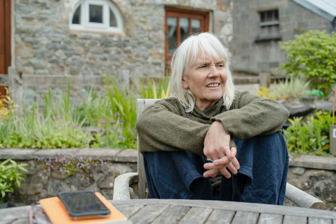 senior woman smiling with phone